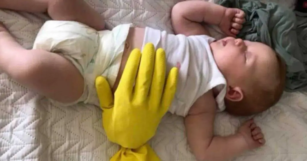 Baby sleeping with weighted glove