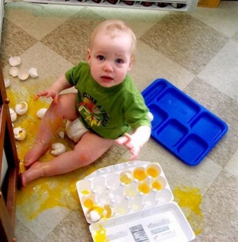 Baby with eggs smashed everywhere