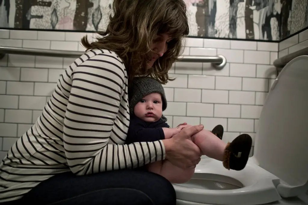 Mom with baby in public toilet