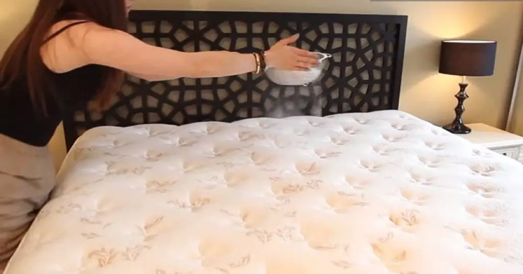 sprinkling baking soda on mattress
